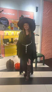 Woman in a witch Halloween costume inside Lady L Cannabis store